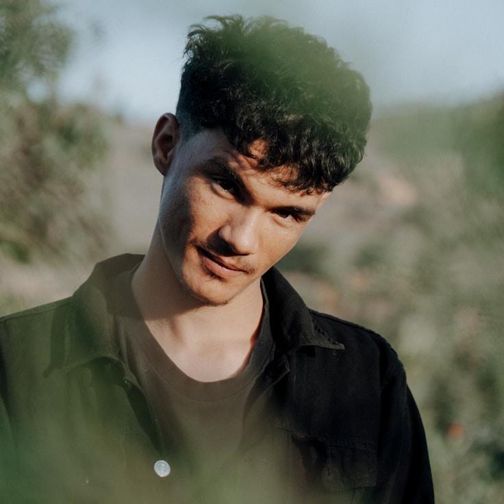 Ari Chen, Lead Design Curator at Strategic Value Platform, reviewing corporate floral arrangements